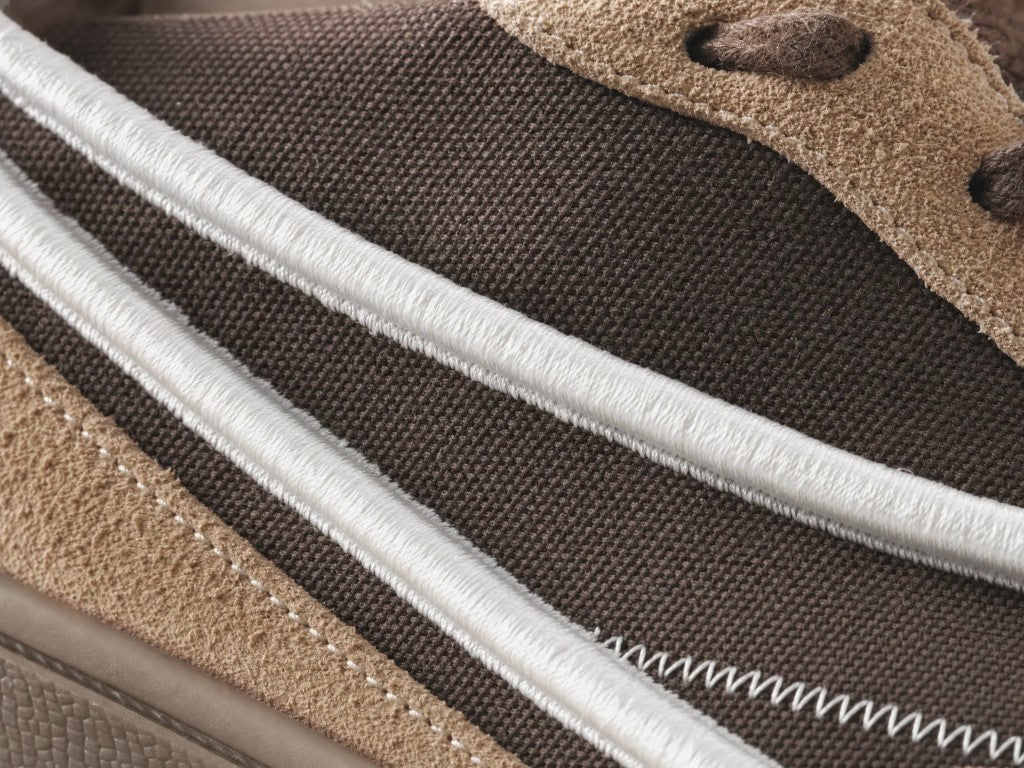 White 3D embroidery on brown canvas